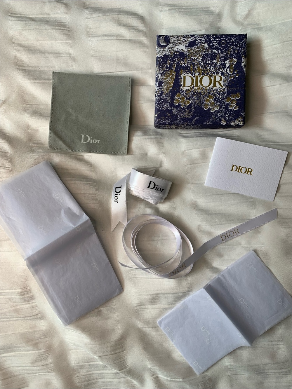 Empty dior jewelry box and ribbons with wrapping paper